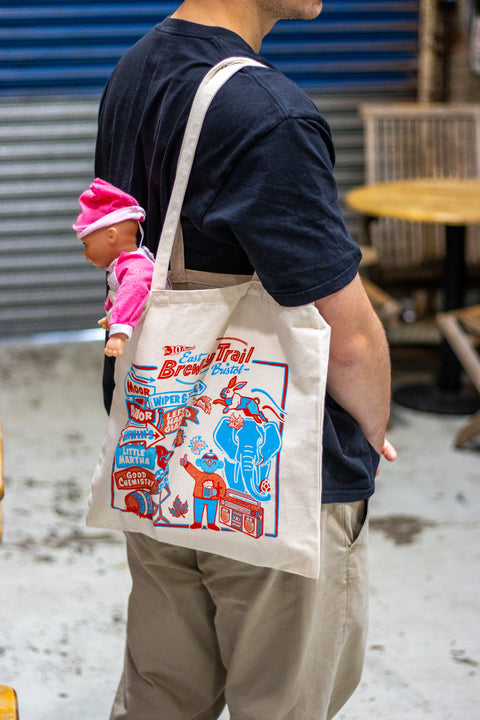 Man holding a tote bag with children's toys in it