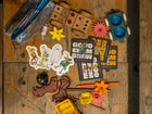 Mix of good chem merch on a wooden table surrounded by toys