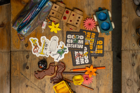 Mix of good chem merch on a wooden table surrounded by toys