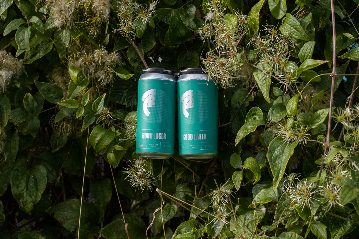 Cans of Good Lager in greenery